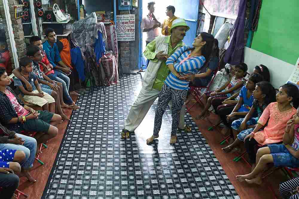 Acting teacher Baburao Ladsaheb shows off dance moves with a student during a class at the 'Five Star Acting Dancing Fighting Classes' in Mumbai's Dharavi slums August 18, 2019. u00e2u20acu201d AFP pic
