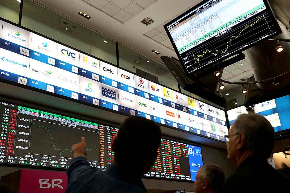 People are seen in front of an electronic board showing ecent fluctuations of market indices on the floor of Brazil's B3 Stock Exchange in Sao Paulo July 25, 2019. u00e2u20acu201d Reuters pic