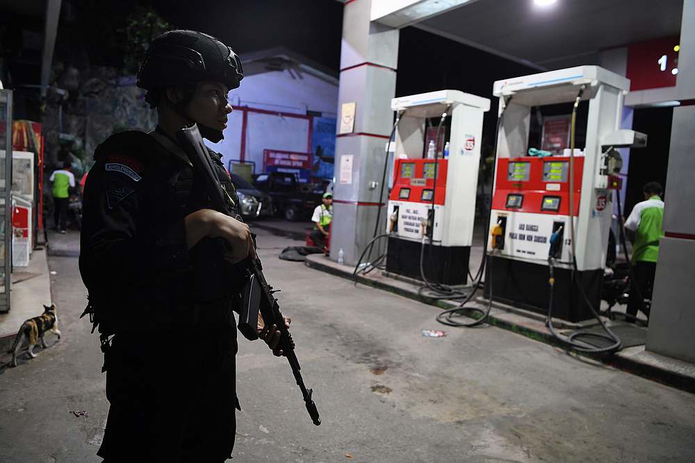 Police Mobile Brigade (Brimob) officer stands guard at a gas station in Jayapura, Papua, August 31, 2019. u00e2u20acu201d Antara Foto/Zabur Karuru pic via Reuters