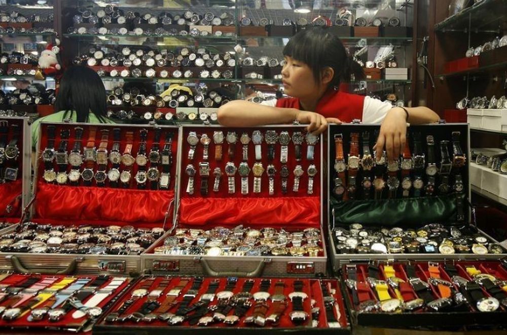 A shopkeeper, selling fake foreign brand watches, waits for customers in Beijing May 8, 2008. u00e2u20acu201d Reuters pic