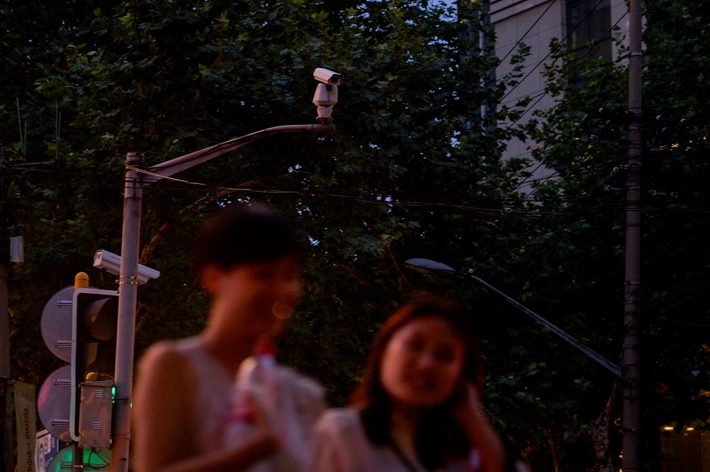 In this file photograph taken on August 9, 2017, people walk before a facial recognition camera at an intersection in Shanghai. u00e2u20acu2022 AFP pic         
