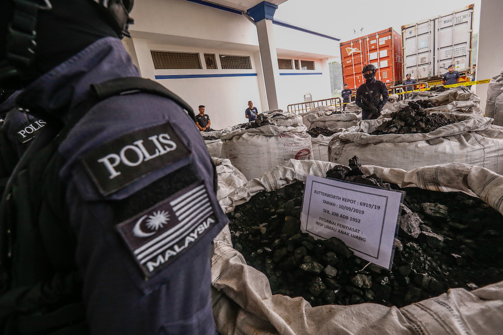 Police guard the 12 tonnes of cocaine seized from three containers at Bayan Baru Police Station September 20, 2019. u00e2u20acu201d Picture by Sayuti Zainudin