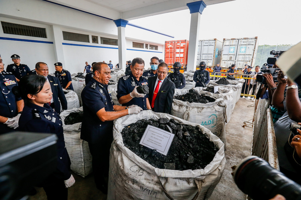 Inspector General of Police Tan Sri Abdul Hamid Bador and other officers examine the 12-tonnes of cocaine seized from three containers at Bayan Baru Police Station September 20, 2019. — Picture by Sayuti Zainudin