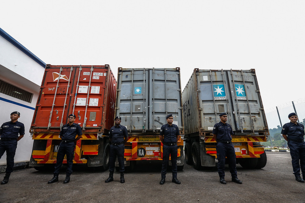 Police guard the 12 tonnes of cocaine seized from three containers at Bayan Baru Police Station September 20, 2019. — Picture by Sayuti Zainudin