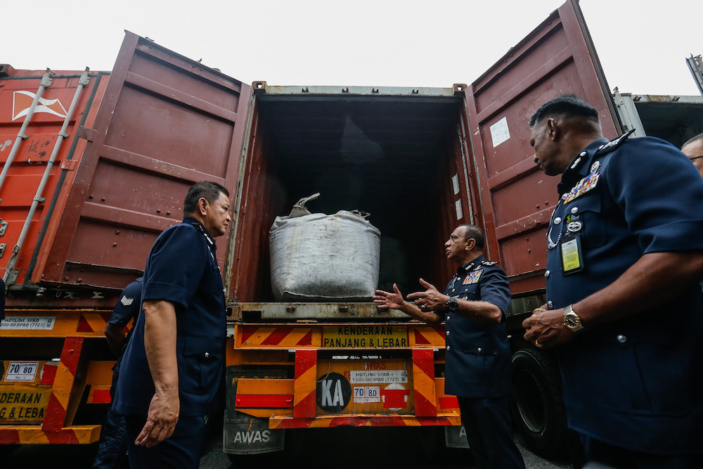 Inspector General of Police Tan Sri Abdul Hamid Bador and other officers examine the 12-tonnes of cocaine seized from three containers at Bayan Baru Police Station September 20, 2019. — Picture by Sayuti Zainudin