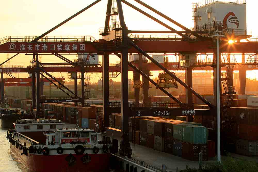 A cargo ship is seen next to containers at a river port during sunset in Huaian, Jiangsu province, China September 14, 2019. u00e2u20acu201d Reuters pic