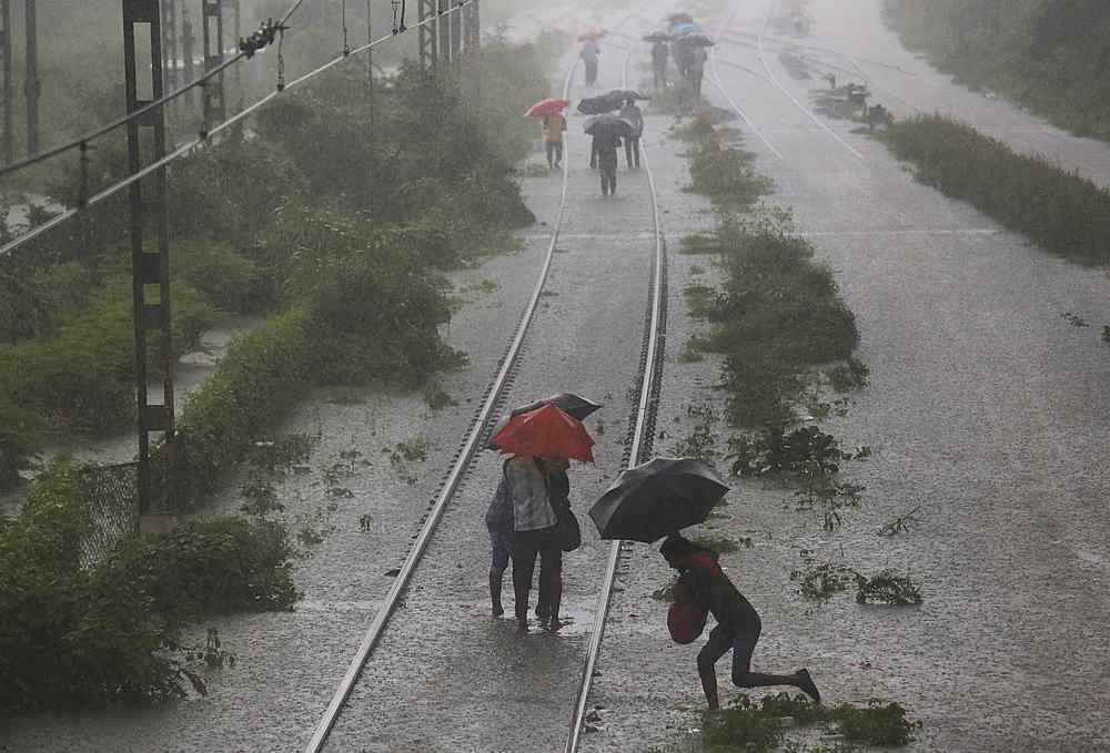 Commuters walk on a flooded railway track after a heavy rainfall in Mumbai, India September 4, 2019. u00e2u20acu201d Reuters pic