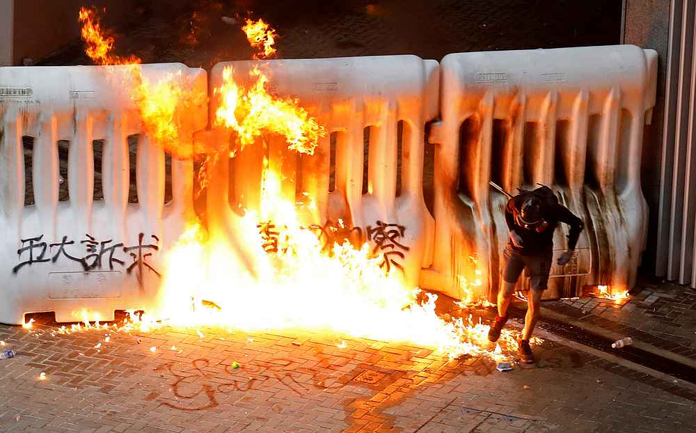 A demonstrator runs away from a burning barricade during a protest in Hong Kong August 31, 2019. u00e2u20acu201d Reuters pic 