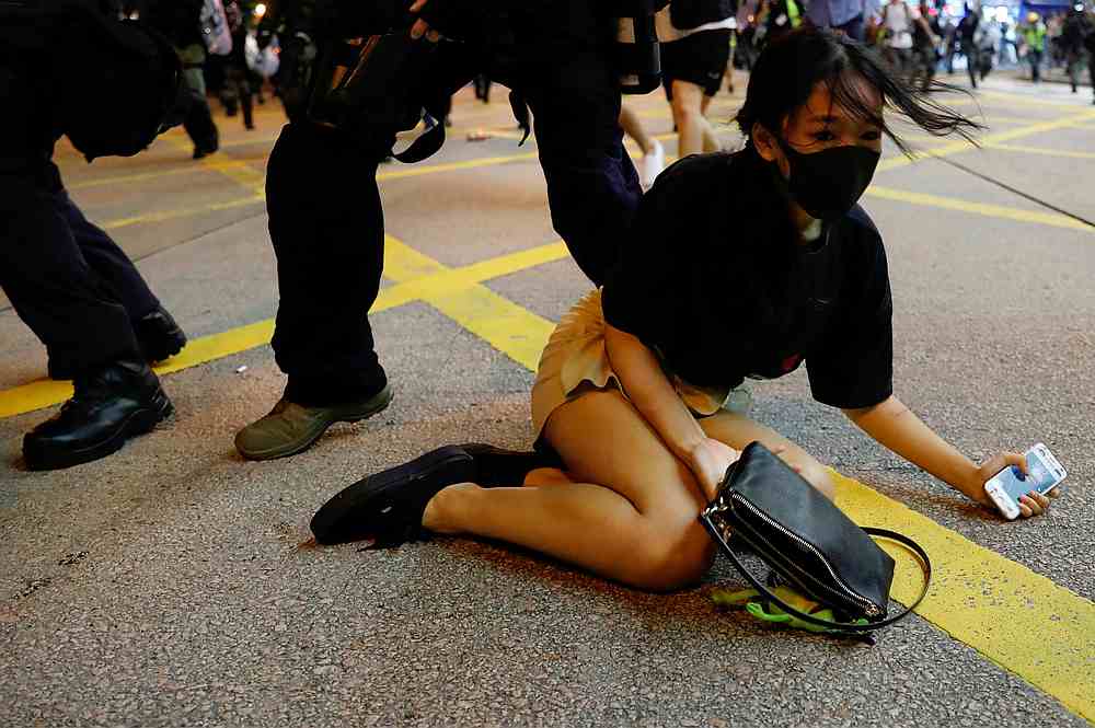 Riot police detain a woman during a protest near Mong Kok police station in Hong Kong September 7, 2019. — Reuters pic