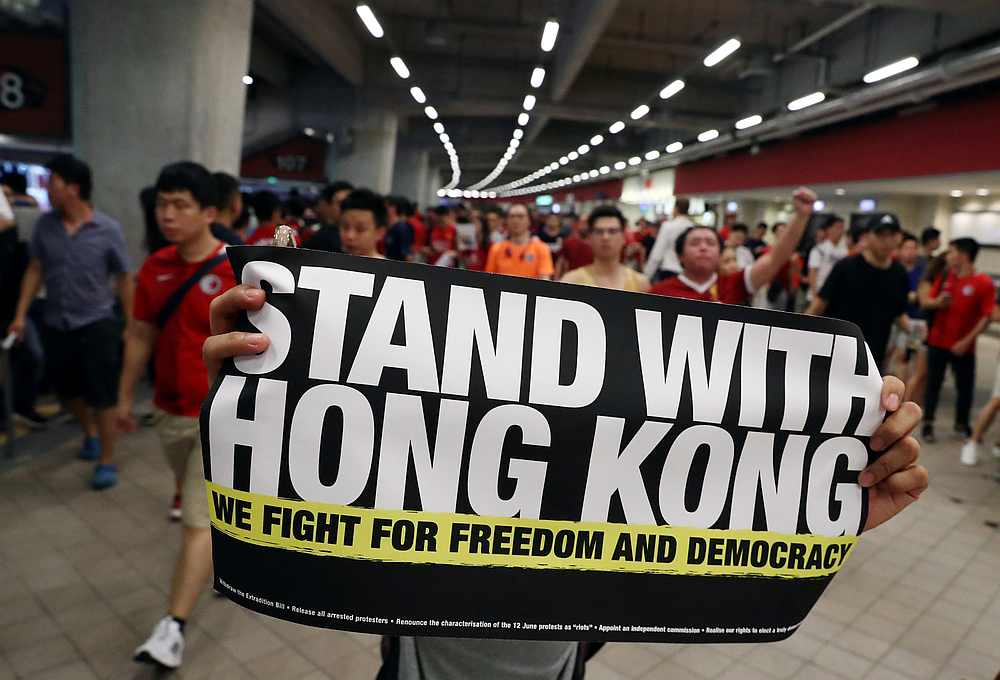 A demonstrator holds a sign in support of anti-government protesters at a football World Cup qualifier match between Hong Kong and Iran, at Hong Kong Stadium September 10, 2019. u00e2u20acu201d Reuters pic