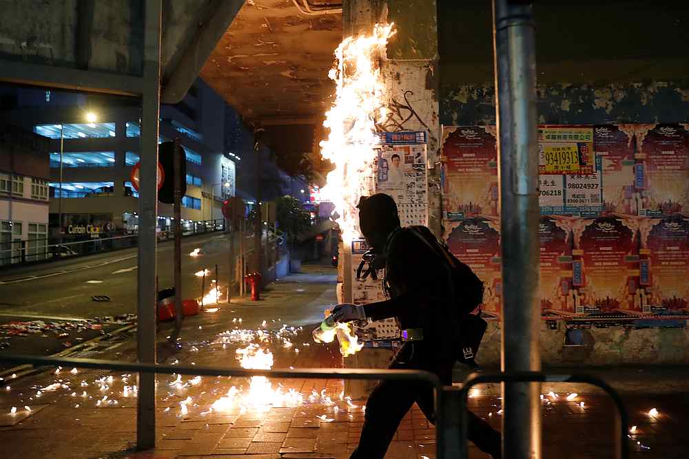 An anti-government protester throws a lit molotov cocktail after retreat from the clash with riot police in Hong Kong September 29, 2019. u00e2u20acu201d Reuters pic