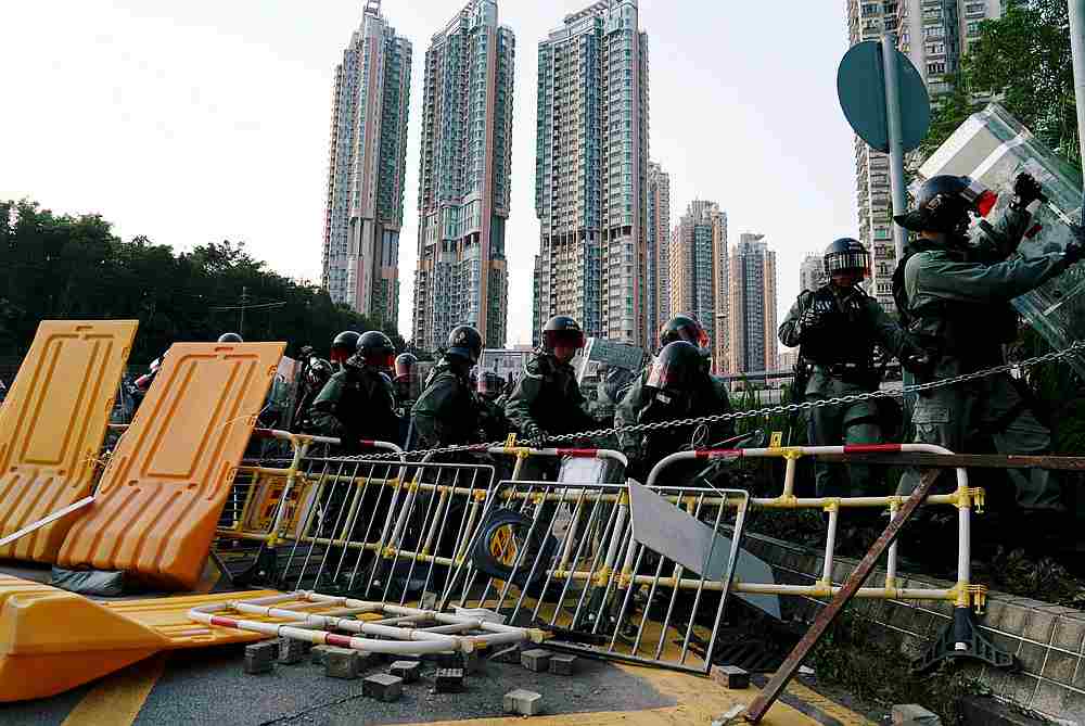 Riot police officers remove a barricade in Tuen Mun, Hong Kong September 21, 2019. u00e2u20acu201d Reuters pic