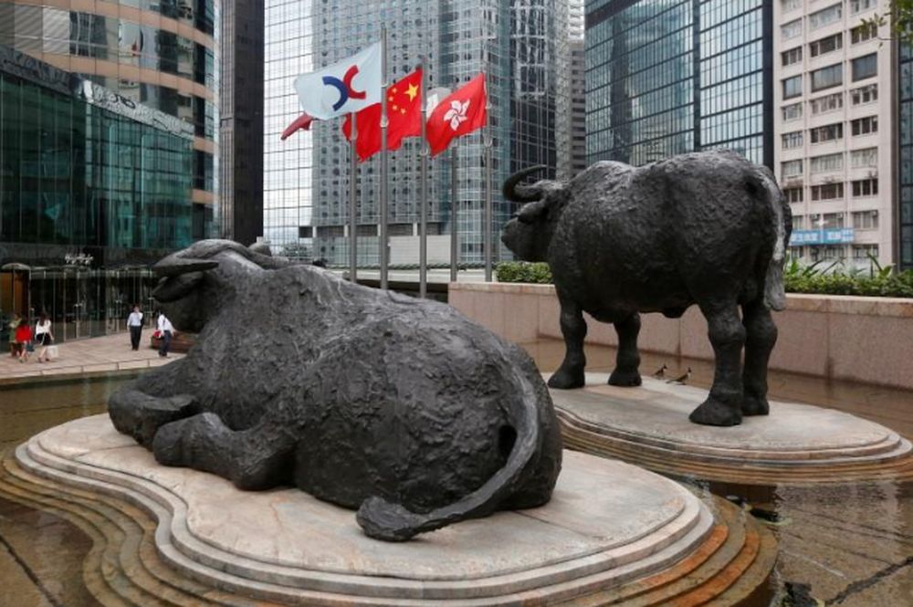 (From left) The Hong Kong Exchanges flag, Chinese national flag and Hong Kong flag are hoisted outside the Hong Kong Stocks Exchange in Hong Kong, June 7, 2016. u00e2u20acu201d Reuters pic