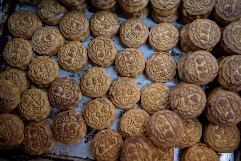 This picture taken on September 10, 2019 shows mooncakes, adorned with a popular slogan from recent pro-democracy protests, being prepared for the annual mid-autumn festival at a bakery in Hong Kong. — AFP pic