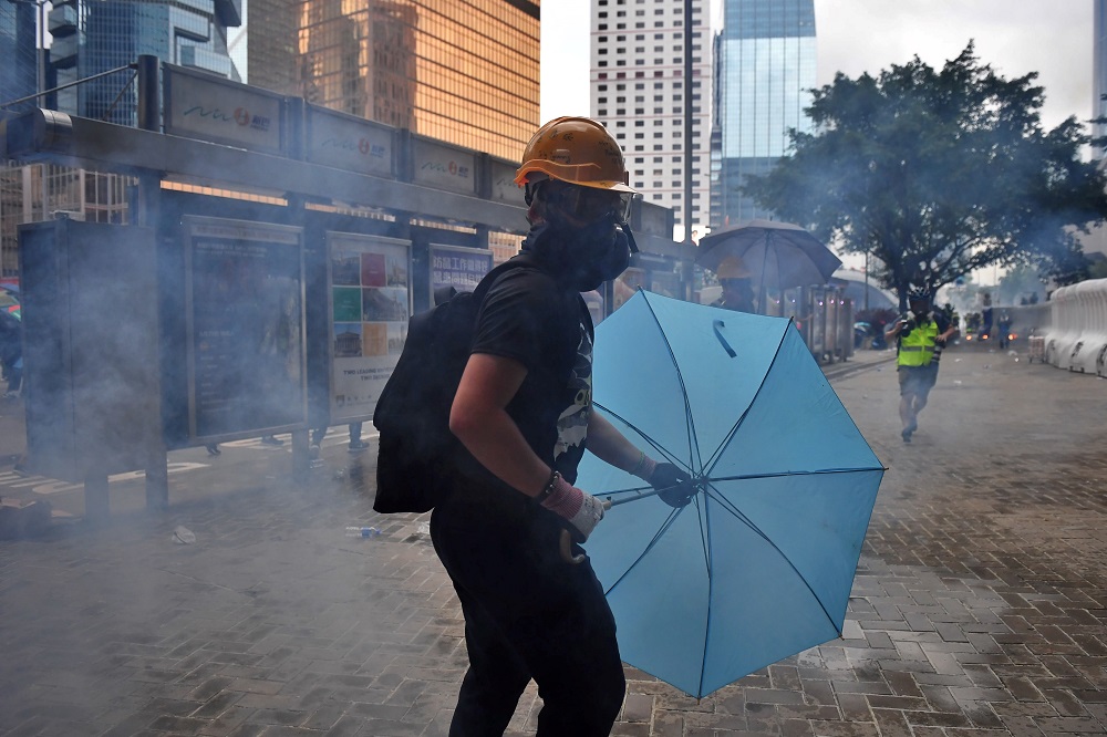 This photo taken on August 31, 2019 shows protester u00e2u20acu02dcRyanu00e2u20acu2122 standing amongst tear gas fired by police outside the Legislative Council in Hong Kong. u00e2u20acu201d AFP pic       