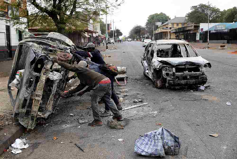 Scrap metal collectors prepare to transport a shell of a car after it was burnt during xenophobic attacks in Johannesburg, South Africa September 5, 2019. u00e2u20acu201d Reuters pic