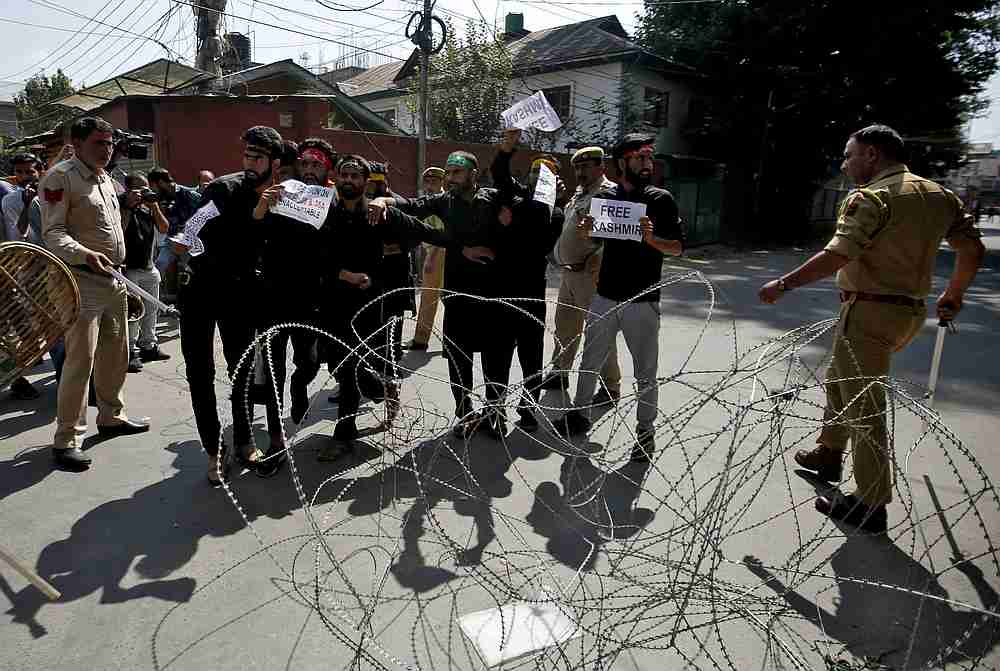 Kashmiri Shi'ite Muslims shout slogans behind concertina wire as they are stopped by Indian police while trying to participate in a procession in Srinagar September 8, 2019. u00e2u20acu201d Reuters pic