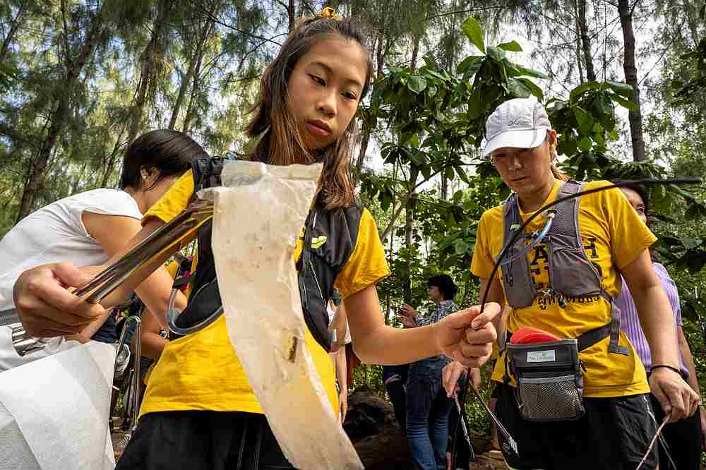 Ralyn Satidtanasarn, 12, known by her nickname Lilly, collects plastic waste during the Trash Hero cleaning initiative at the Khung Bang Kachao urban forest and beach in Bangkok August 25, 2019. u00e2u20acu201d AFP pic