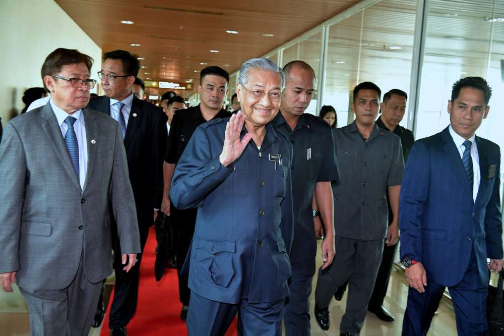 Tun Dr Mahathir Mohamad waves before boarding the aircraft at the Kuching International Airport, September 17, 2019. u00e2u20acu2022 Bernama pic