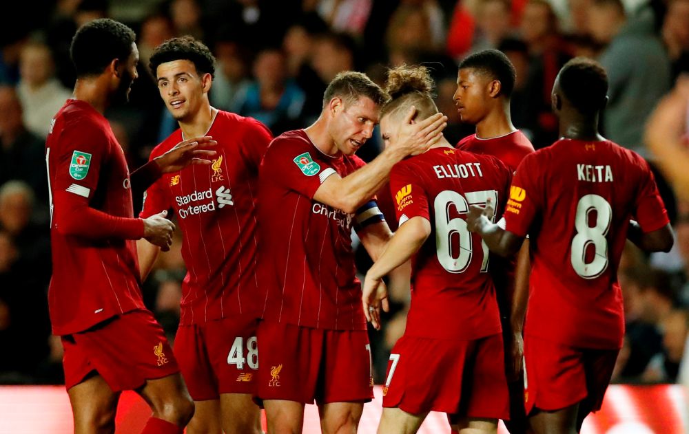 Liverpool's James Milner (second from left) celebrates scoring their first goal against MK Dons with teammates. u00e2u20acu201d Reuters pic