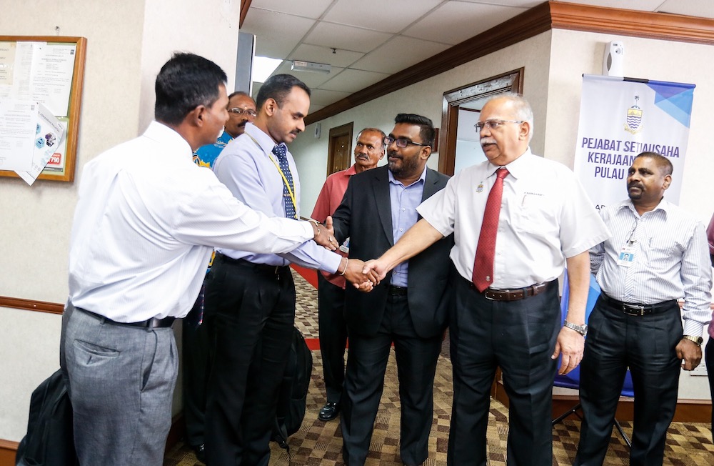 Deputy Chief Minister II P. Ramasamy (middle) and Bagan Dalam assemblymen M. Satees (2nd right) are seen after giving their statements to Bukit Aman officers in George Town September 11, 2019. u00e2u20acu201d Picture by Sayuti Zainudin