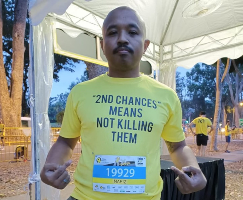 Nafiz Kamarudin and his wife wore the T-shirts at a run September 15, 2019 organised by the Yellow Ribbon Project in Singapore aimed at showing support for ex-offenders. u00e2u20acu201d Picture from Facebook/Nafiz SerbaBoleh