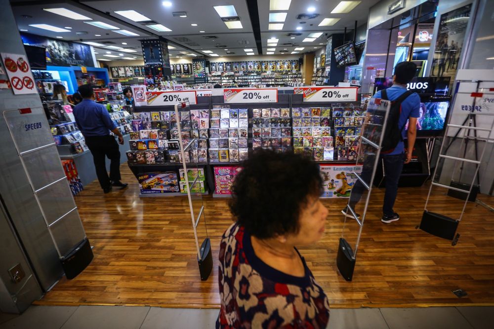 Customers are pictured perusing CDs at Speedy Video Mid Valley Megamall September 10, 2019. — Picture by Hari Anggara
