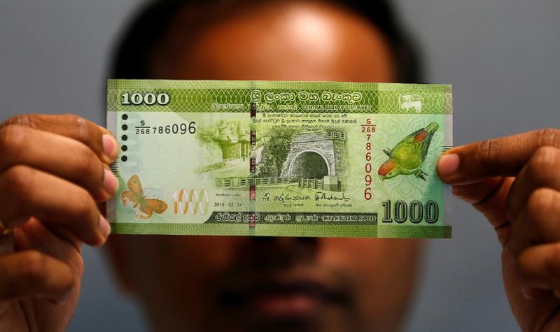 A man shows a thousand rupee note in this illustration photo taken September 7, 2018. u00e2u20acu201d Reuters pic