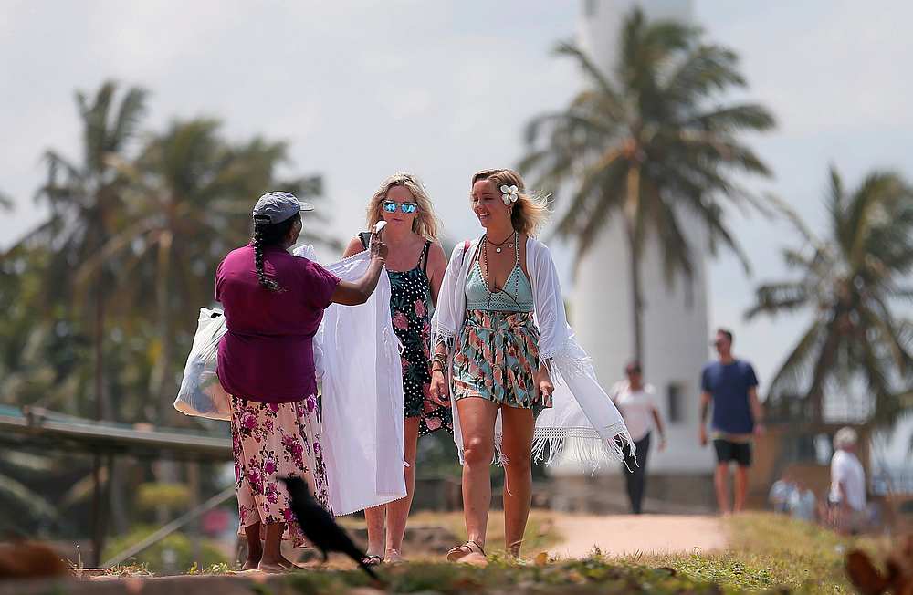 A local vendor tries to sell handmade items to tourists at Dutch Fort in Galle, Sri Lanka July 11, 2019. u00e2u20acu201d Reuters pic