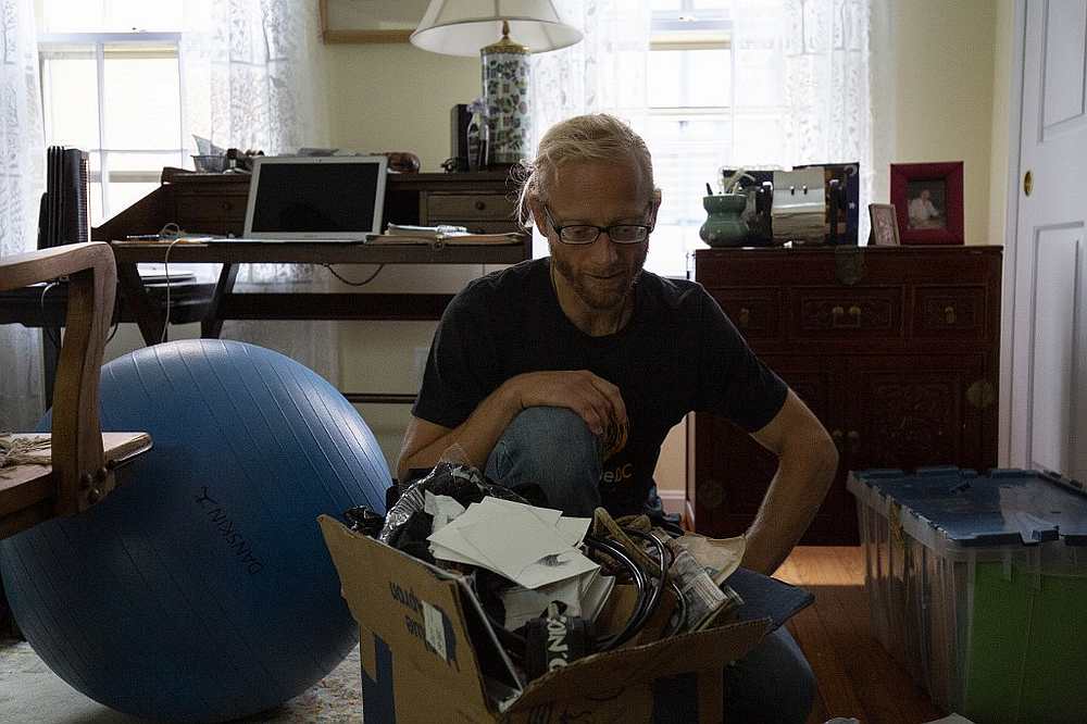 Tarek Maassarani looks at a box of items he is planning on discarding at his friend's home in Washington September 13, 2019. u00e2u20acu201d AFP pic