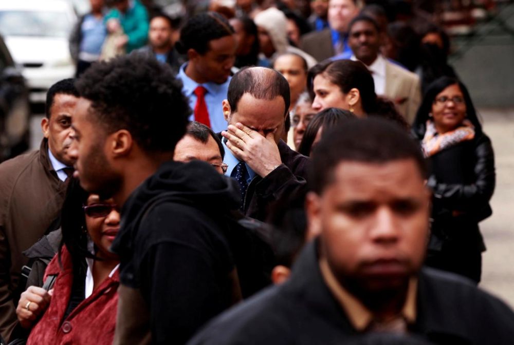 A man rubs his eyes as he waits in a line of job seekers, to attend the Dr. Martin Luther King Jr. career fair held by the New York State department of Labor in New York April 12, 2012. u00e2u20acu201d Reuters pic