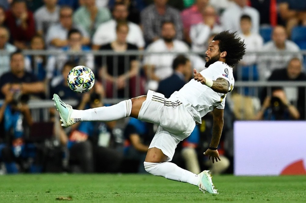 Real Madridu00e2u20acu2122s Marcelo kicks the ball during the Uefa Champions League Group A match with Club Brugge at the Santiago Bernabeu stadium in Madrid October 1, 2019. u00e2u20acu201d AFP pic