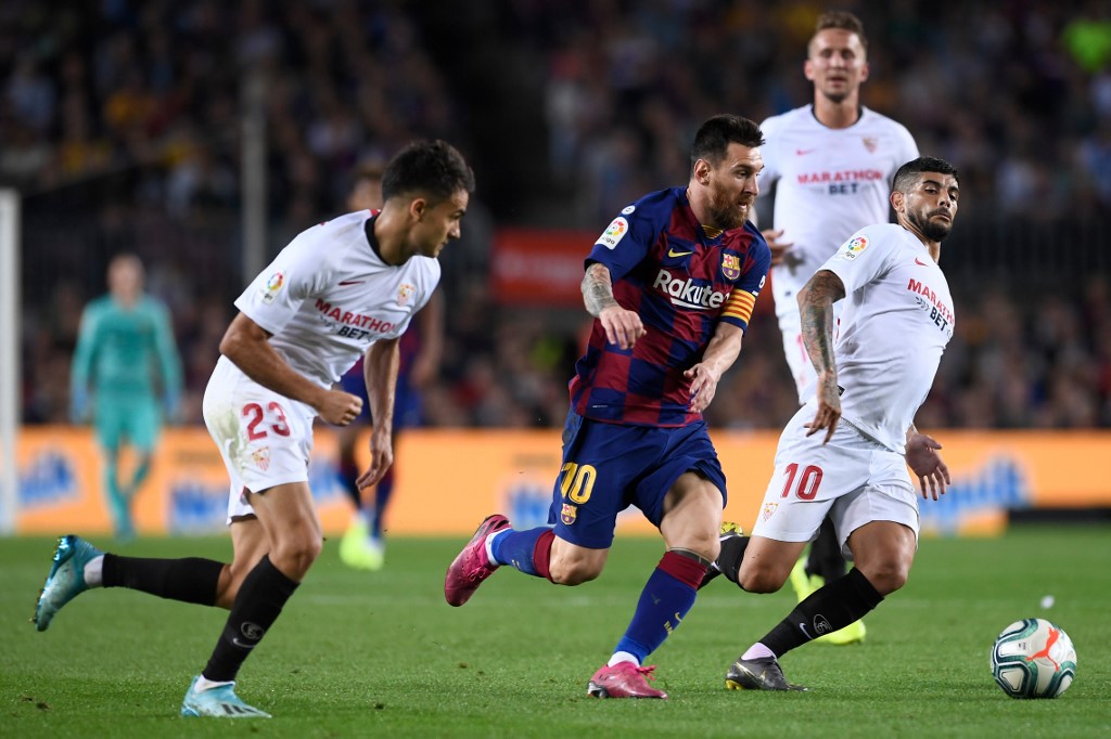 Barcelonau00e2u20acu2122s Lionel Messi vies with Sevillau00e2u20acu2122s Ever Banega (right) during the match between FC Barcelona and Sevilla FC at the Camp Nou stadium in Barcelona October 6, 2019. u00e2u20acu201d AFP pic