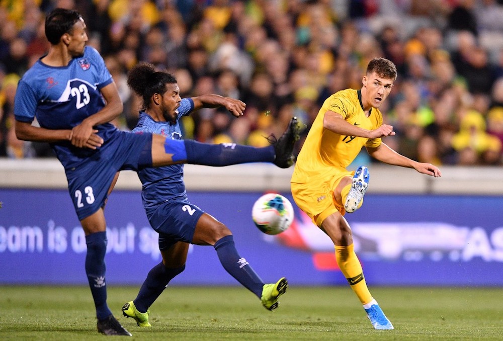 Australia’s Ajdin Hrustic shoots past Nepal’s Rohit Chand and Rajeen Dhimal during their World Cup Qatar 2022 qualification match in Canberra October 10, 2019. — AFP pic