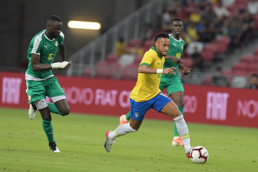 Brazilu00e2u20acu2122s Neymar dribbles past Senegalu00e2u20acu2122s Salif Sane and Racine Coly during the friendly international match at the National Stadium in Singapore October 10, 2019. u00e2u20acu201d AFP pic