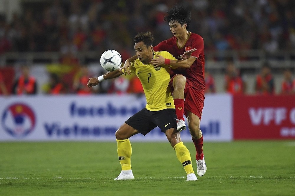 Vietnam’s Nguyen Tuan Anh fights for the ball with Malaysia’s Mohamad Aidil Zafuan during their Qatar 2022 World Cup qualifying match at My Dinh stadium in Hanoi October 10, 2019. — AFP pic