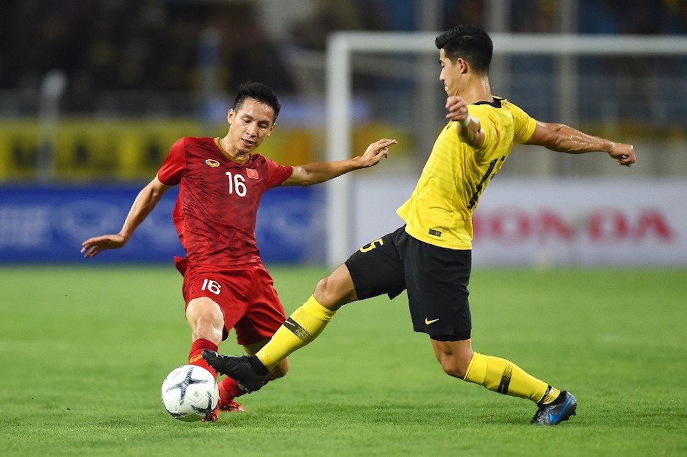 Vietnamu00e2u20acu2122s Do Hung Dung fights for the ball with Malaysiau00e2u20acu2122s Brendan Gan during their Qatar 2022 World Cup qualifying match at My Dinh stadium in Hanoi October 10, 2019. u00e2u20acu201d AFP pic