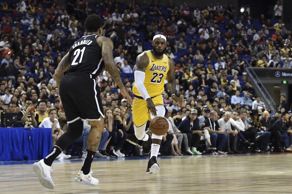 LeBron James of the Los Angeles Lakers drives the ball in front of Wilson Chandler of the Brooklyn Nets during their NBA pre-season match in Shanghai October 10, 2019. u00e2u20acu201d AFP pic