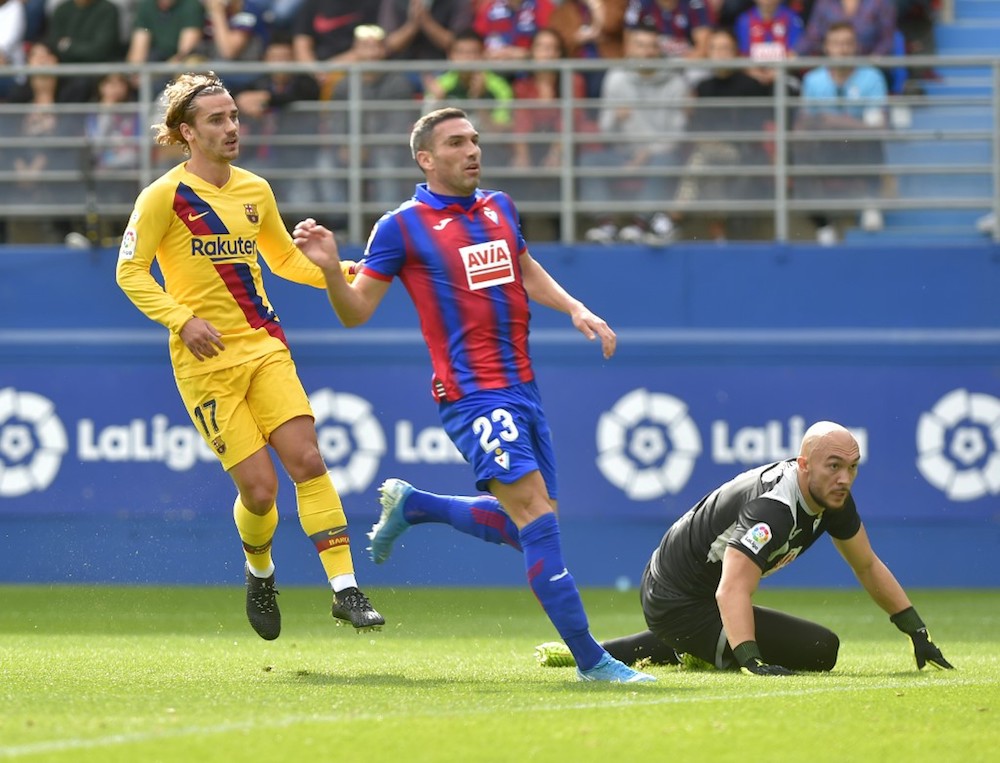 Barcelonau00e2u20acu2122s Antoine Griezmann scores against Eibaru00e2u20acu2122s Serbian goalkeeper Marko Dmitrovic during the La Liga match with Eibar at the Ipurua stadium in Eibar October 19, 2019. u00e2u20acu201d AFP pic