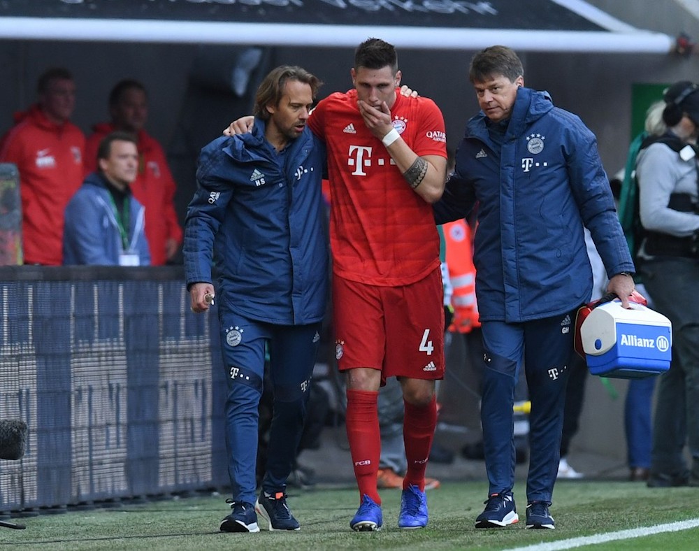 Munichu00e2u20acu2122s defender Niklas Suele is helped off after an injury during the Bundesliga match with Augsburg in Augsburg October 19, 2019. u00e2u20acu201d AFP pic