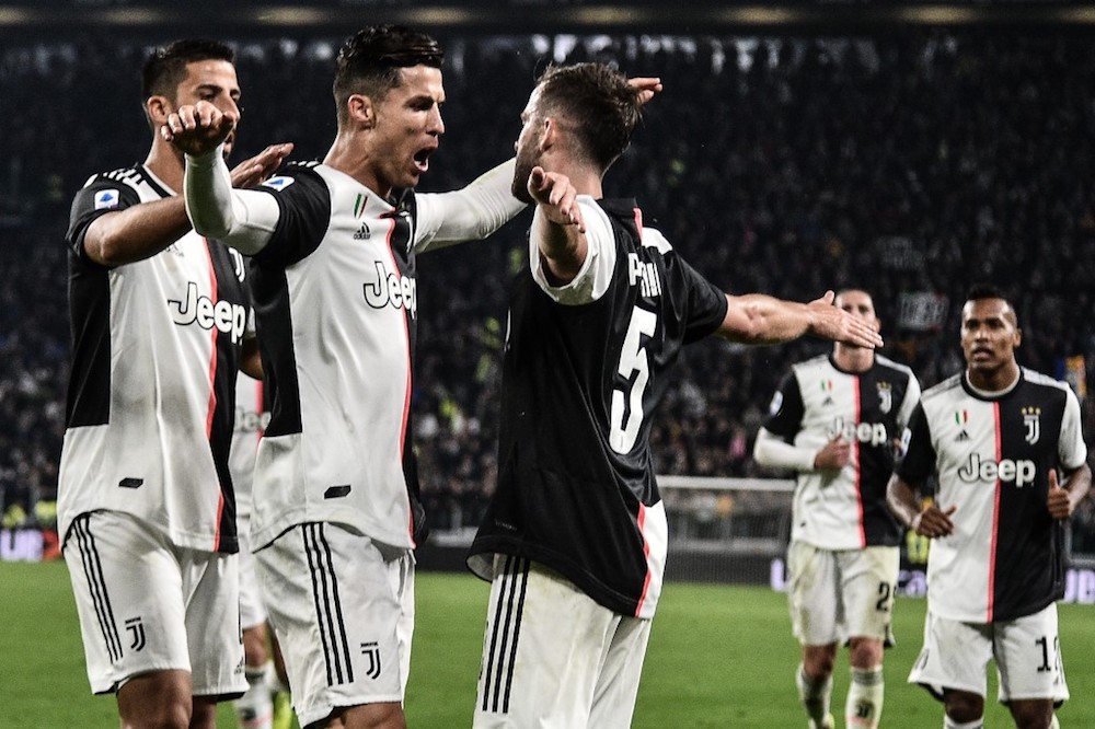 Juventusu00e2u20acu2122 Miralem Pjanic celebrates with Cristiano Ronaldo and Sami Khedira after scoring during the Serie A match with Bologna at the Juventus stadium in Turin October 19, 2019. u00e2u20acu201d AFP pic