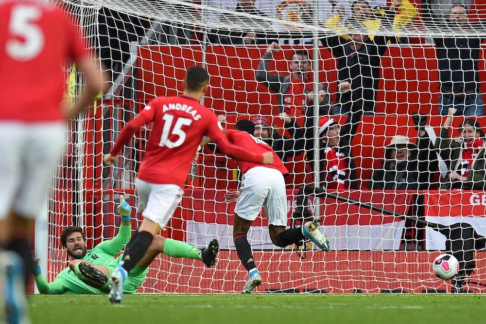 Manchester Unitedu00e2u20acu2122s Marcus Rashford scores the opening goal past Liverpoolu00e2u20acu2122s goalkeeper Alisson Becker during their English Premier League match at Old Trafford in Manchester October 20, 2019. u00e2u20acu201d AFP pic