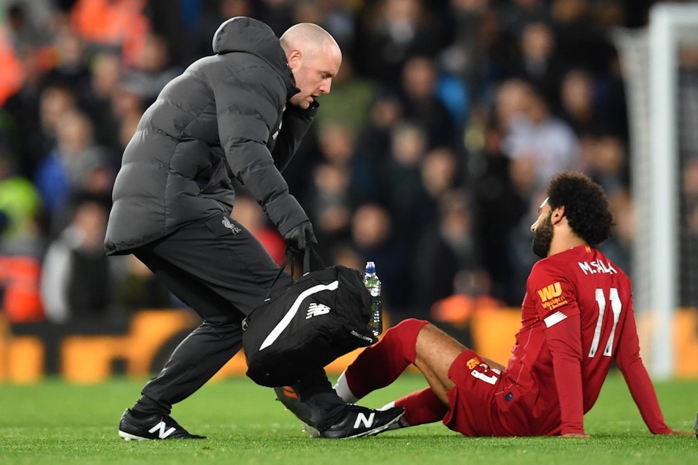Liverpoolu00e2u20acu2122s Mohamed Salah is seen to by a medic during the Premier League match with Tottenham Hotspur at Anfield in Liverpool October 27, 2019. u00e2u20acu201d AFP pic