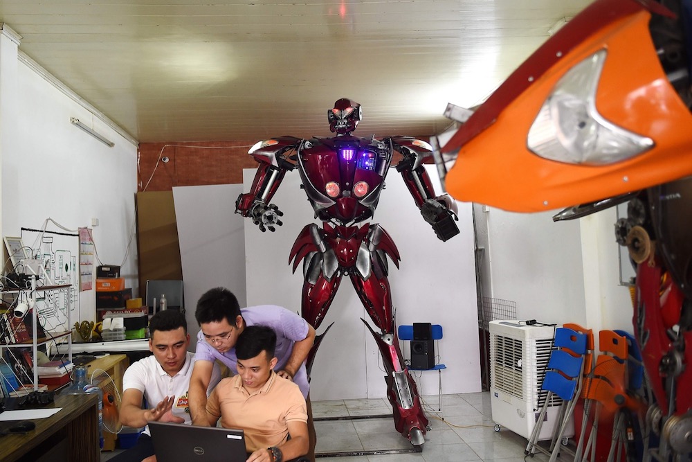 This photograph taken on September 30, 2019 shows a Vietnamese team of engineers and programmers checking u00e2u20acu02dcRobot-Oneu00e2u20acu2122, made from spare motorcycle parts, at a workshop in Hanoi. u00e2u20acu201d AFP pic