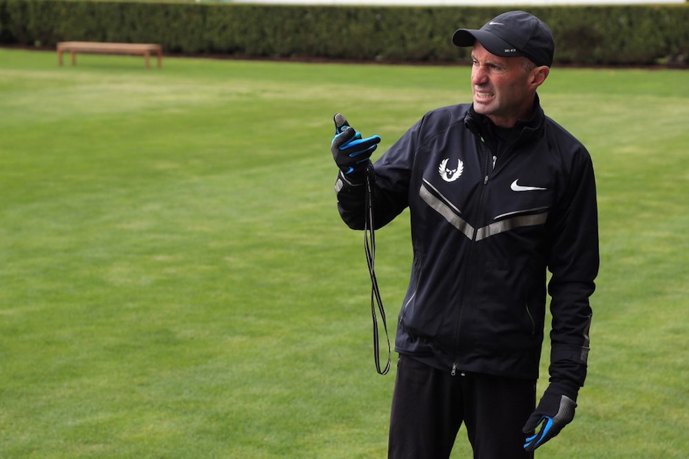 Coach Alberto Salazar of the Nike Oregon Project times athletes as they train on the grass at the Nike campus in Beaverton, Oregon April 13, 2013. u00e2u20acu201d AFP pic
