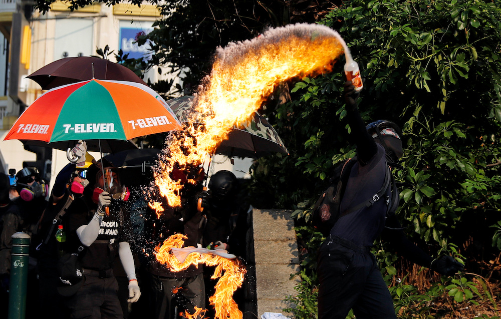 An anti-government demonstrator throws a petrol bomb towards Tsim Sha Tsui Police Station during a protest in Hong Kong October 20, 2019. u00e2u20acu201d Reuters pic