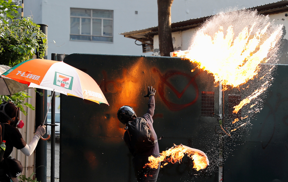 An anti-government demonstrator throws a petrol bomb towards Tsim Sha Tsui Police Station during a protest march in Hong Kong October 20, 2019. u00e2u20acu201d Reuters pic