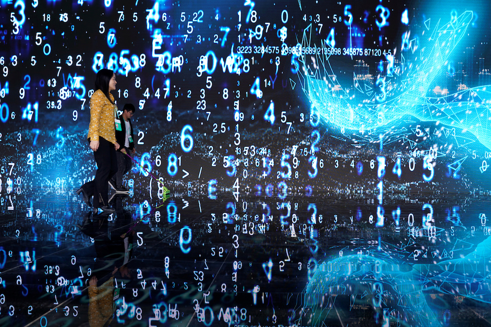 People walks in front of a screen at the World Internet Conference (WIC) in Wuzhen, Zhejiang province October 20, 2019. u00e2u20acu201d Reuters pic