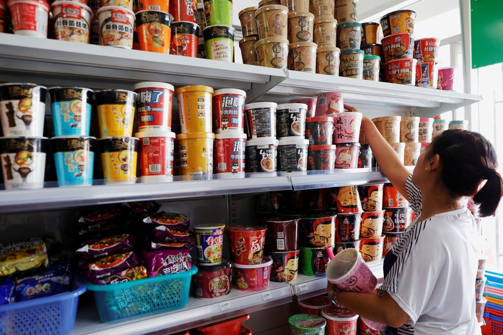 A saleslady arranges Chinese instant noodles in a Chinese grocery store in Pasay City, Metro Manila June 14, 2019. u00e2u20acu201d Reuters pic