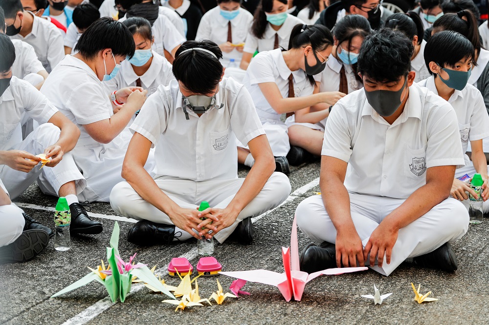 Schoolmates of a student protester who was shot by a policeman sit beside paper cranes while participating in a student gathering at Tsuen Wan Public Ho Chuen Yiu Memorial College in Hong Kong October 2, 2019. u00e2u20acu201d Reuters pic